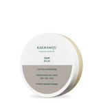 CALM balm in a round white Karmameju tin with a grey-brown label on a white background
