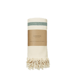 Rolled cream Hammam towel with green stripe, fringed ends and a brown Karmameju paper band