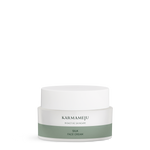 SILK face cream in a frosted Karmameju jar with white lid and green label on a white background