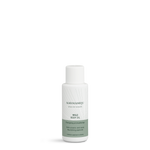 WILD body oil travel size in a small white Karmameju bottle with a green label on a white background